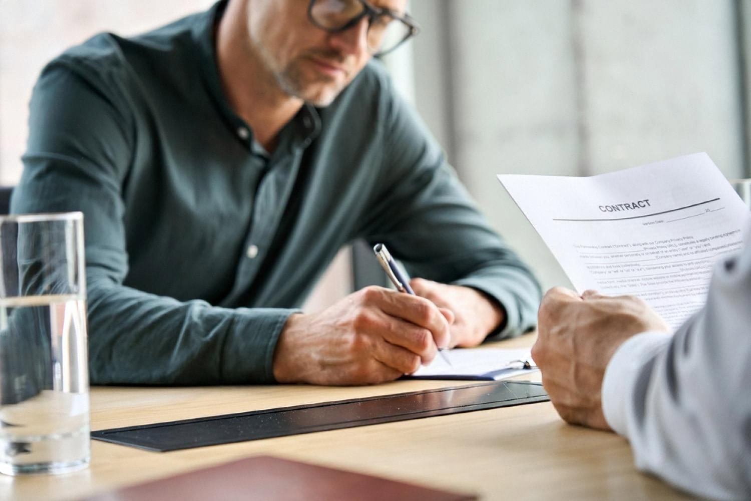 HR consultant reviewing and signing an employment contract in the UAE